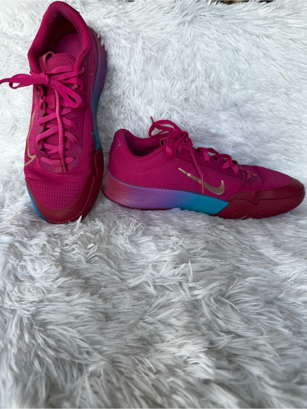 Nike Women's Bold Pink Athletic Court Shoes with Teal Purple Gradient Accent.
